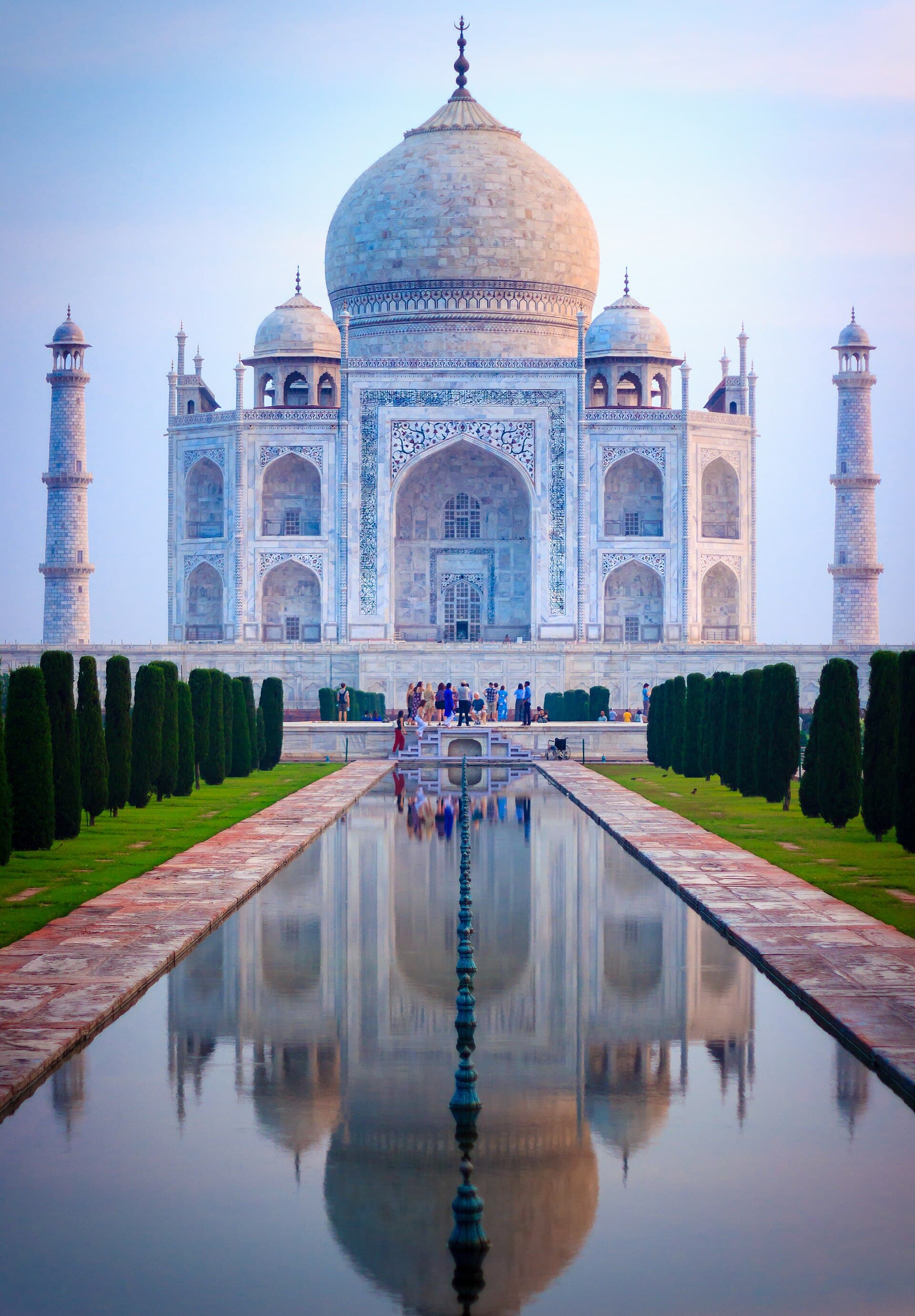 The Taj Mahal glowing in soft pink light at sunrise